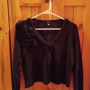 Black button down shirt with ruffles.